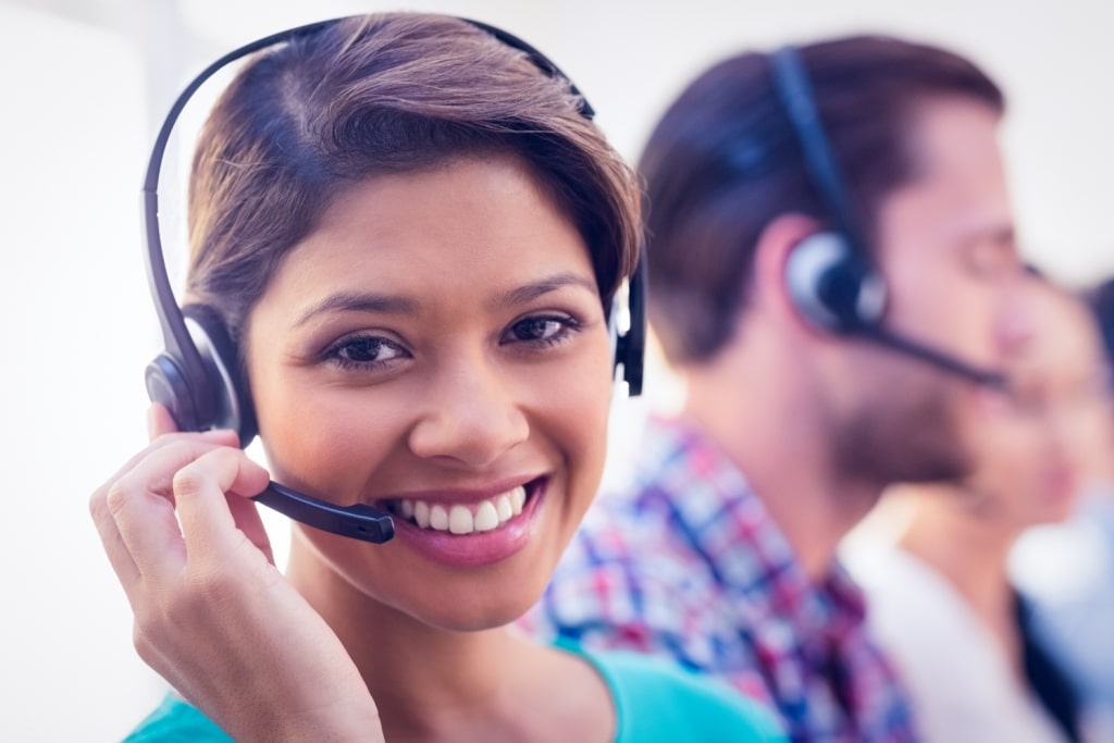 stock-photo-close-up-plan-of-a-smiling-businesswoman-in-a-call-centre-295924556