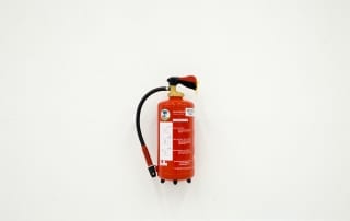 Fire extinguisher mounted on a wall and installed by CIA